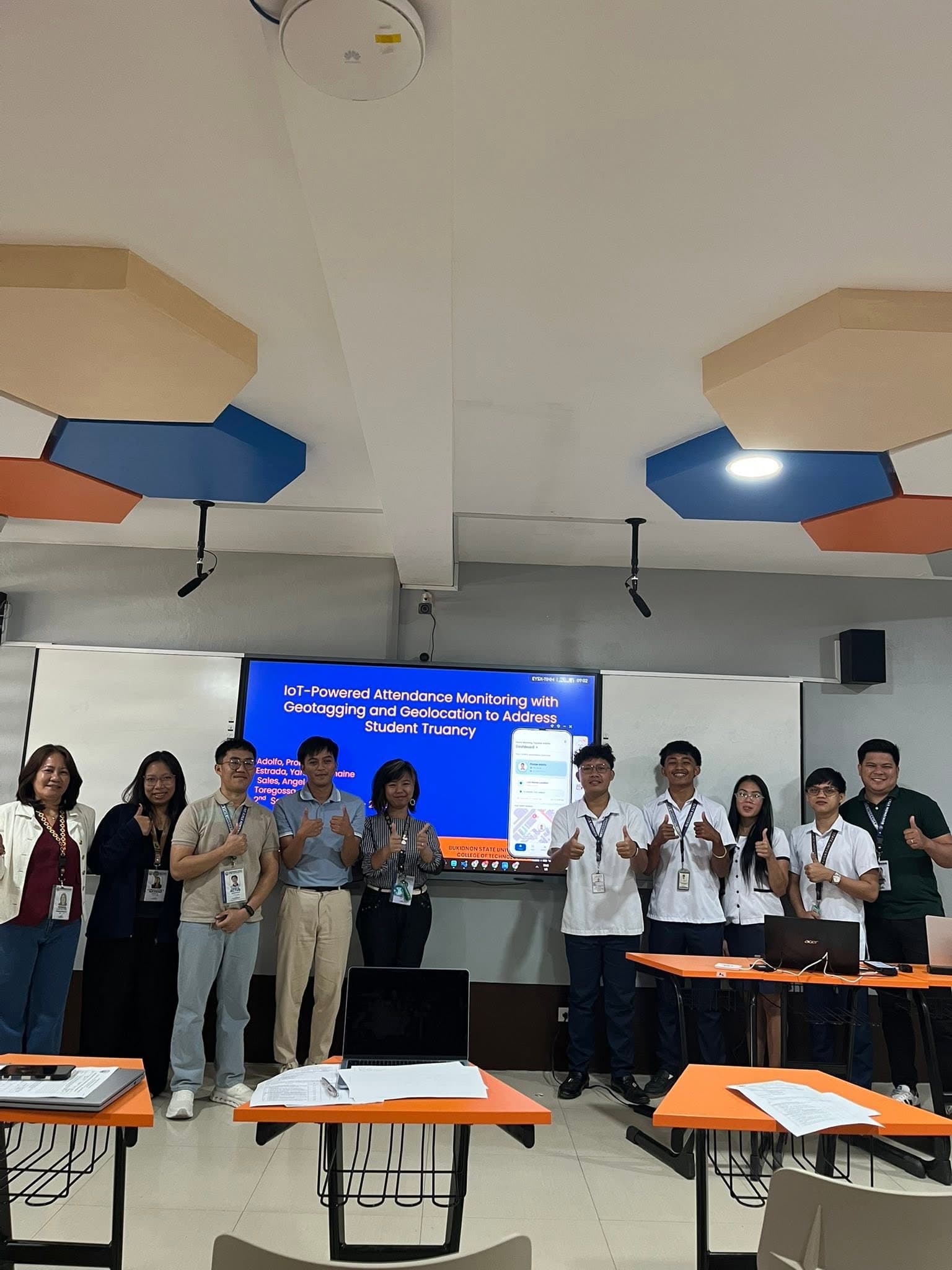 The full defense panel, adviser, and student team posing together after the defense